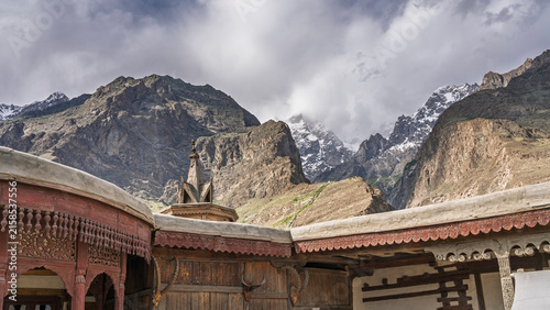 Scenic landscape view of Karakoram mountains under cloudy sky above ancient Baltit fort, Karimabad, Hunza, Gilgit Baltistan, Pakistan