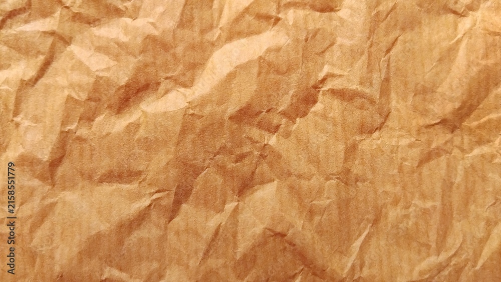 Fototapeta premium Crumpled brown paper texture background close up