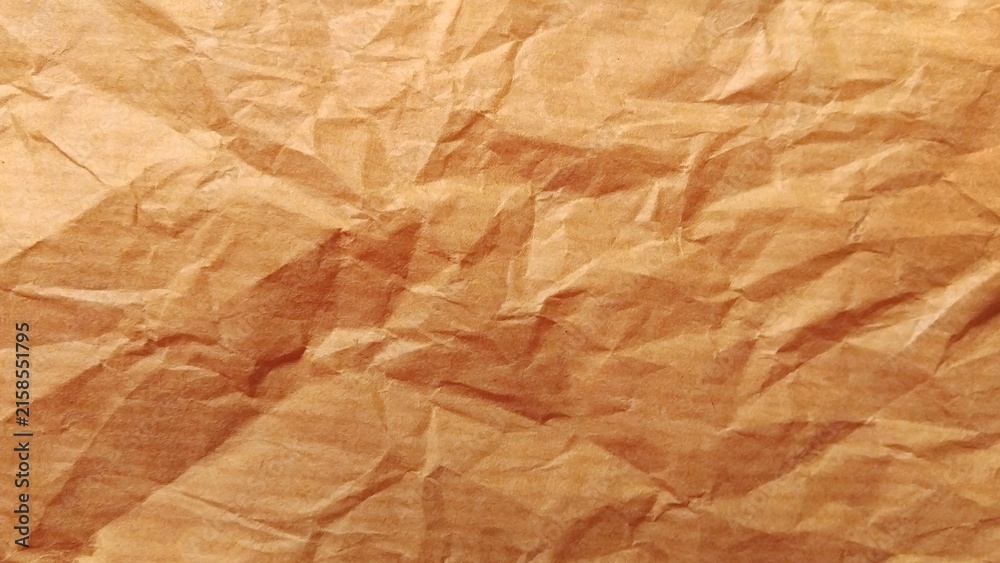 Fototapeta premium Brown crumpled craft paper background, crumpled paper texture