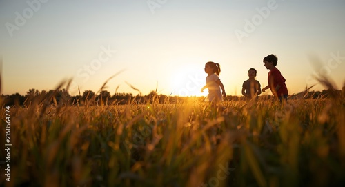 Children playing summer sunset happy time with copy space on left, featuring Outdoors and Evening, with Children Outdoor Sunset, with detailed modern composition, for commercial use, for editorial use