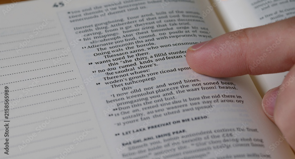 Obraz premium Close up of finger pointing text in Bible with copy space on left, featuring Bible Study and Bible Reading, with Bible Devotion, with detailed modern composition, for commercial use, for editorial use