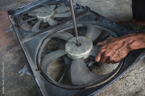 A car radiator cooling fan service ,checks and replaces the electric fan assembly.