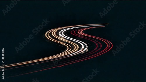Video: time-lapse of a highway with a black background and vehicle headlights 