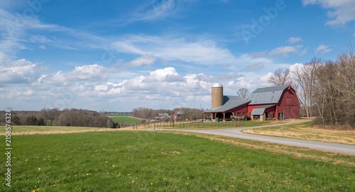 Photo realistic as Countryside and Barn - A half tone countryside scene with a red barn set against a dreamy background offering ample space for text or graphics symbolizing rustic with copy space.