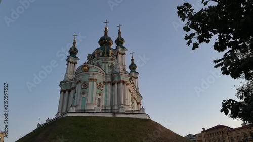 St. Andrew’s Church in Kyiv, Ukraine, featuring Baroque architecture, turquoise and white facade, golden details, onion domes and crosses under a clear blue sky.