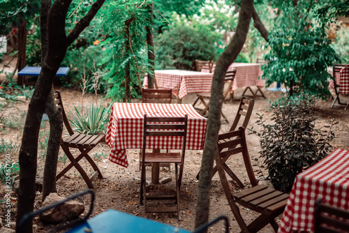 Cozy garden restaurant with red checked tablecloths
