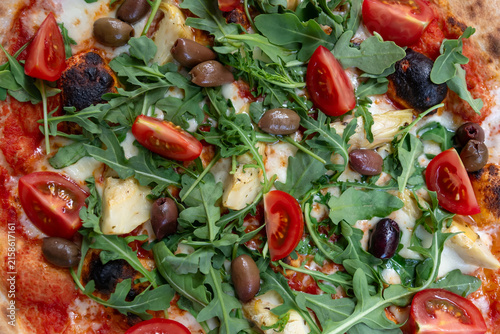 Fresh italian pizza with arugula and olives