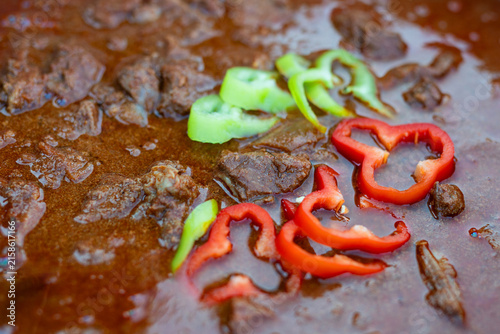 Hungarian beef goulash stew topped with peppers