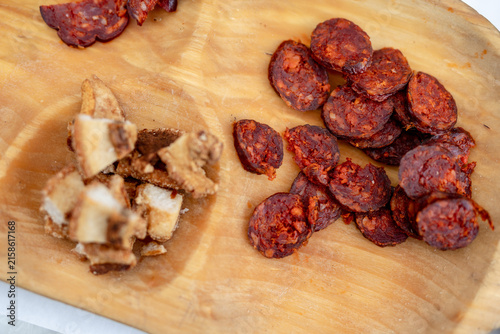 Sliced spicy sausage and crispy pork cracklings
