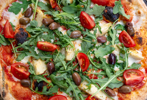 Fresh italian pizza with arugula and olives