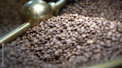 Coffee Beans Roasting: Close-up shot of freshly roasted coffee beans tumbling in a roaster, showcasing their rich color and aroma.