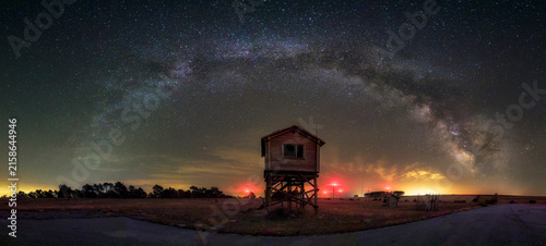 Bild auf Leinwand Milky way galaxy shining over an old wooden control tower at an abandoned airfie