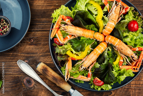 Gourmet Seafood Salad with Langoustines on Green Background