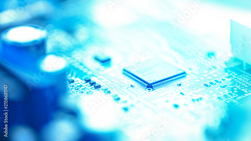 Obraz na płótnie Soft blue microchip circuit board background with glowing light and shallow focus