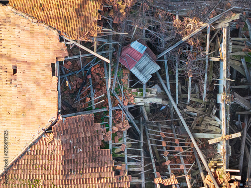 Aerial view of the collapsed roof structure of a fire-damaged building with broken tiles and exposed wooden beams in Belgrade, Serbia.