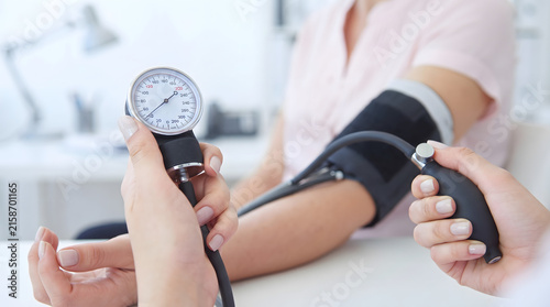Doctor Checking Patient Blood Pressure