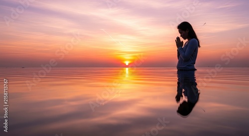 Woman Praying at Sunset by the Sea.