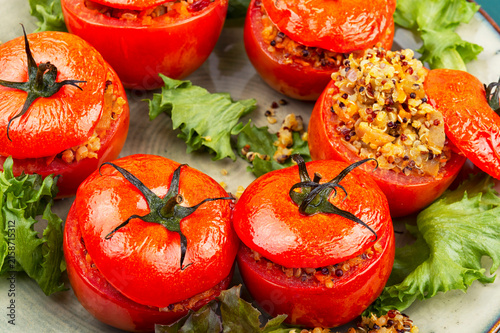Baked Tomatoes Stuffed with Quinoa and Vegetables on Rustic Plate