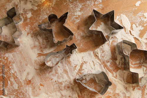 Bild auf Leinwand Baking tools and cookie cutters on a wooden table covered with flour