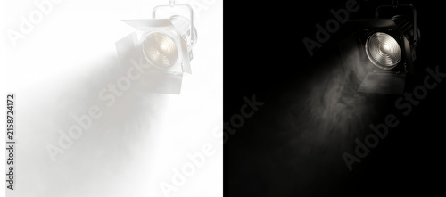 Stage spotlight with cinematic light beam and atmospheric fog, isolated on black background for easy compositing, professional studio lighting effect for posters, event graphics and digital design