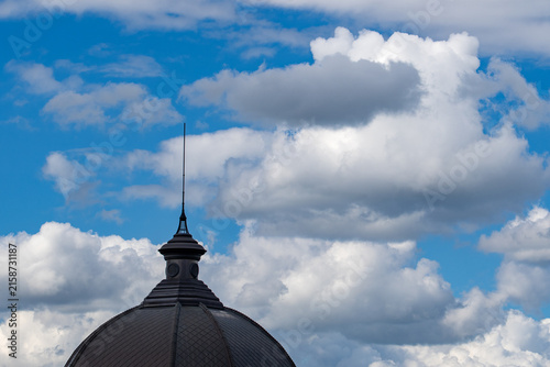 Konstfotografi Architectural detail of a historic dome roof and ornamental spire silhouetted ag