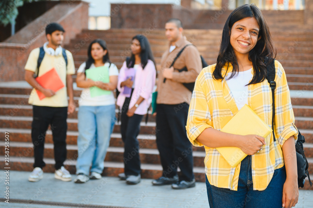 Fototapeta premium Happy indian female student smiling on campus