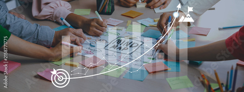 A dynamic brainstorming scene showcasing multiple hands engaged in creating a mind map. Colorful sticky notes and charts enhance the focus on collaborative project planning and innovation. Ledger