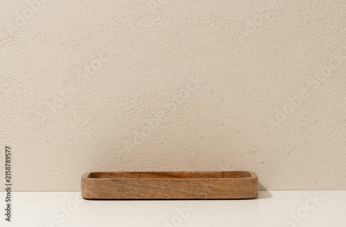 Empty Wooden Tray on White Shelf Against Travertine Wall Background with Copy Space