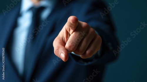 Businessman pointing finger toward camera to select a candidate for leadership.