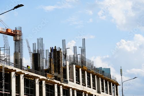 Reinforced concrete building under construction with steel reinforcement bars and formwork system for modern residential and commercial development projects