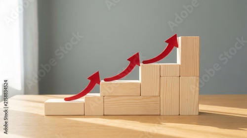 Red arrows pointing up on wooden block steps representing business growth