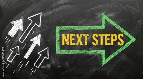 Chalkboard with next steps text and drawn arrows for business growth