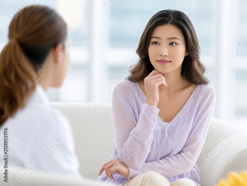Mental Health Therapy Session with Woman and Professional Counselor in Modern Office