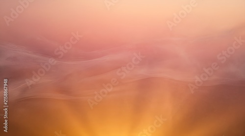 Glowing Golden Light Rays in Warm Mist Abstract Sunbeam Background with Soft Smoke