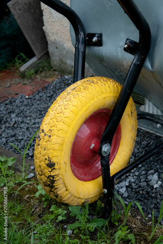 Wheelbarrow on Grass Lawn for Gardening and Landscaping Use.