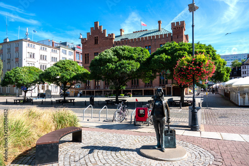 bronze tourist monument on town square near town hall in Kolobrzeg Poland