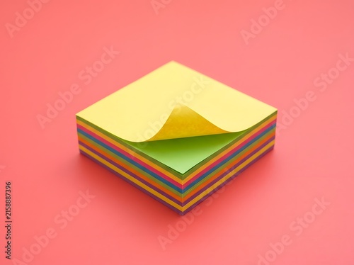 Vibrant Stack of Colorful Sticky Notes on Bright Pink Background for Organization and Ideas
