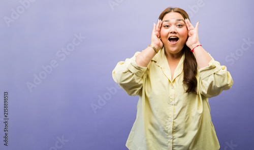 Fotografie Overweight woman reacting with surprise and excitement, receiving shocking news
