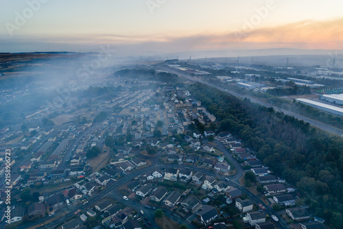 Photography High angle aerial view over residential streets and commercial area engulfed in