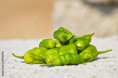 close up of organic green chili peppers healthy food