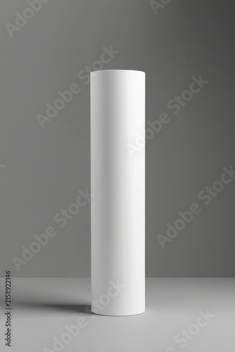 Minimalist white cylinder stands on neutral gray surface