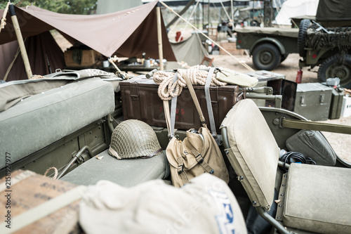 Photography Shallow focus of a classic US Army GI issued helmet seen on the back seat of a WW2 era jeep