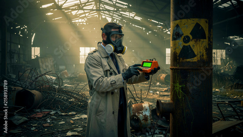 Man in gas mask using radiation detector in ruined factory. Specialist measuring toxicity near radioactive hazard symbol. Nuclear safety concept for environmental risk and disaster training.