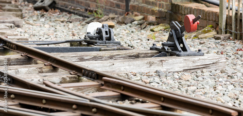 Vintage Railway Switch Lever on Wooden Sleepers by Old Track Mechanism in Rustic Train Yard