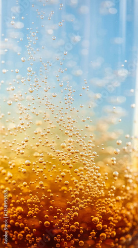 Macro Shot of Carbonated Golden Liquid with Rising Effervescent Bubbles