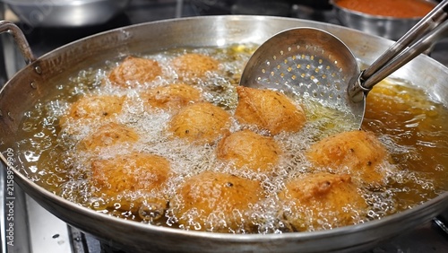 Deep Frying Golden Bean Cakes Akara Acaraje in Large Flat Pan