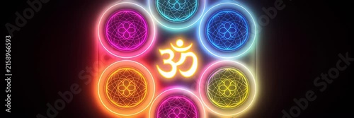 Glowing Om symbol surrounded by colorful chakra circles, spiritual energy concept for meditation website banner
