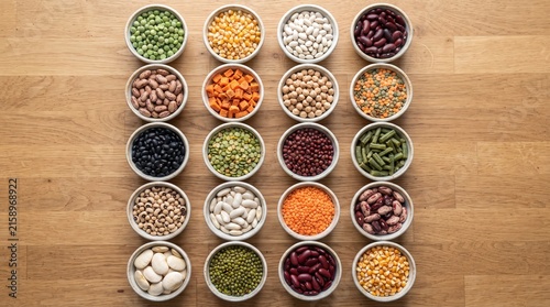 Assortment of colorful dried legumes and beans in wooden bowls for healthy cooking and nutrition