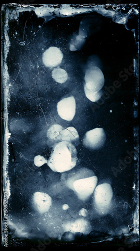 Mysterious dark cyanotype texture with ethereal glowing light orbs