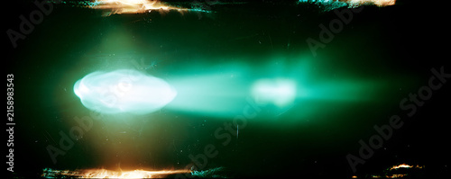 Green anamorphic lens flare optical light leak overlay effect on black background